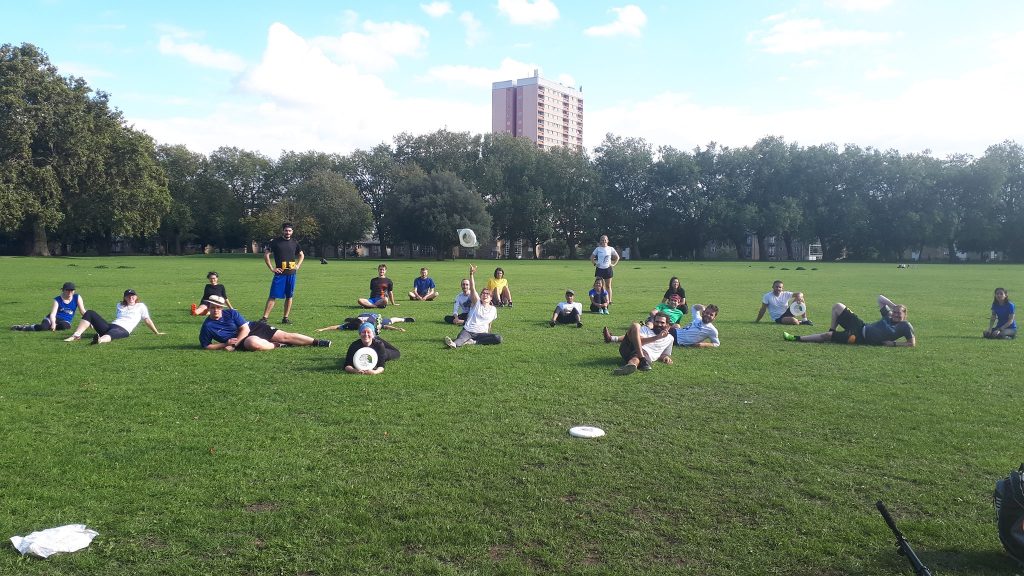Some Ultimate Frisbee players hanging out during a training session